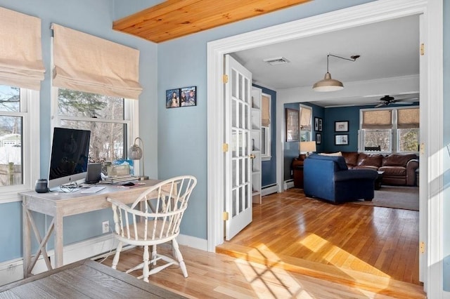 interior space with wood-type flooring, a wealth of natural light, and ceiling fan