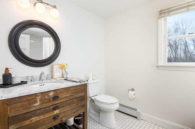 bathroom with vanity, a baseboard heating unit, tile patterned floors, and toilet