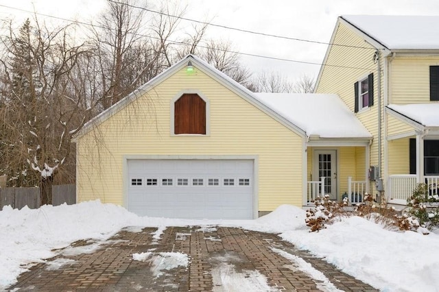 view of front of home with a porch and a garage