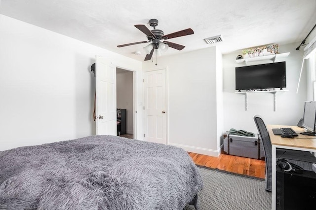 bedroom featuring hardwood / wood-style floors and ceiling fan