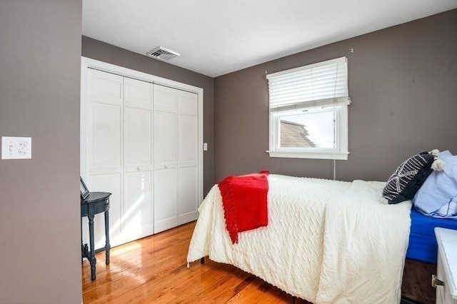 bedroom with wood-type flooring and a closet