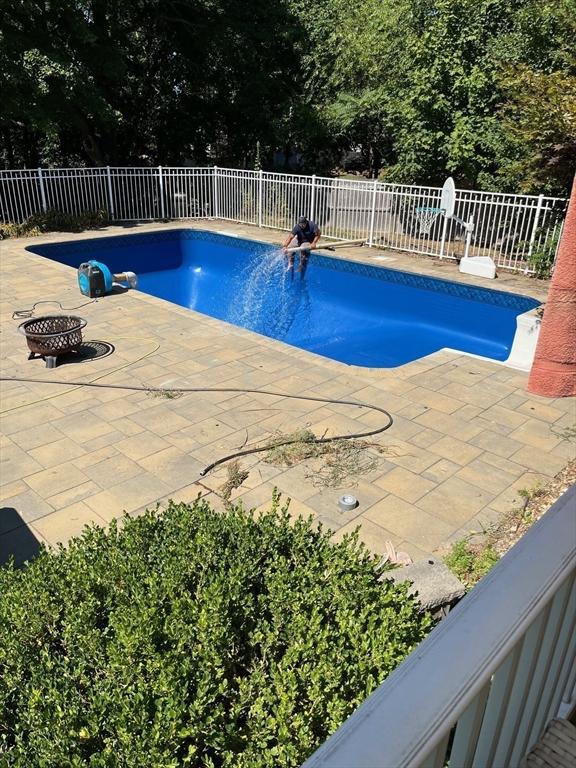 view of pool featuring a patio and a fire pit