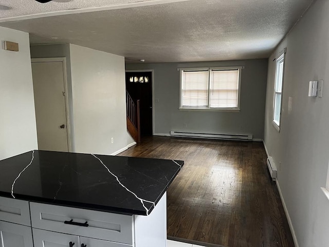 52-54 Campechi St, Springfield, MA 01104 - kitchen featuring baseboard heating, dark wood-style flooring, a baseboard heating unit, a textured ceiling, and dark countertops