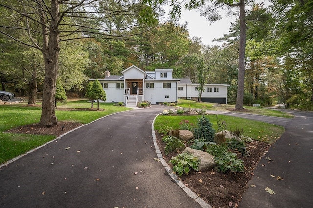 view of front of property with a garage and a front yard