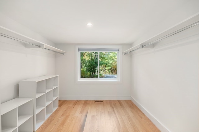 spacious closet with light hardwood / wood-style flooring