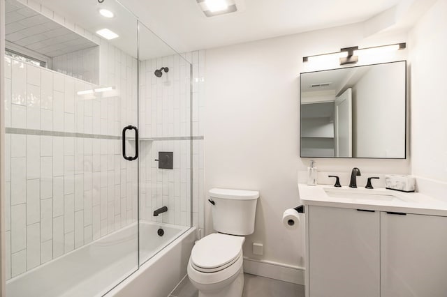 full bathroom featuring bath / shower combo with glass door, vanity, and toilet