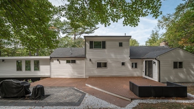 rear view of property with a wooden deck