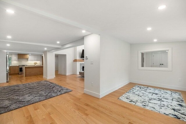 foyer entrance with lofted ceiling and light hardwood / wood-style floors