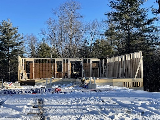 view of snow covered rear of property