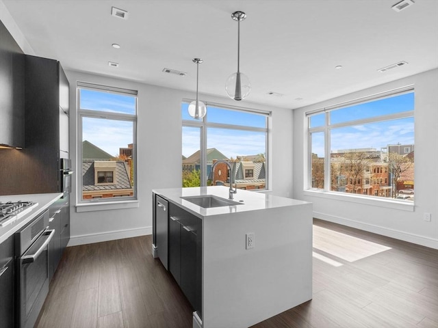 kitchen with visible vents, baseboards, modern cabinets, a sink, and appliances with stainless steel finishes