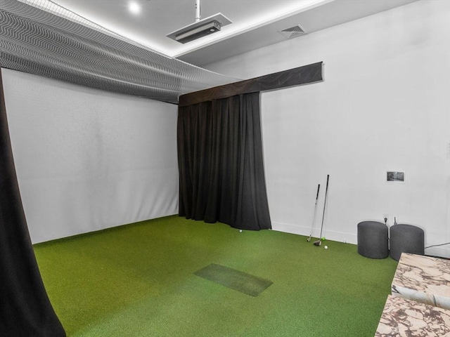 interior space with carpet, golf simulator, and visible vents