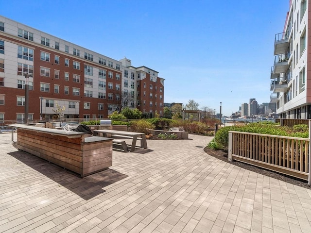 view of home's community featuring a city view and a patio area