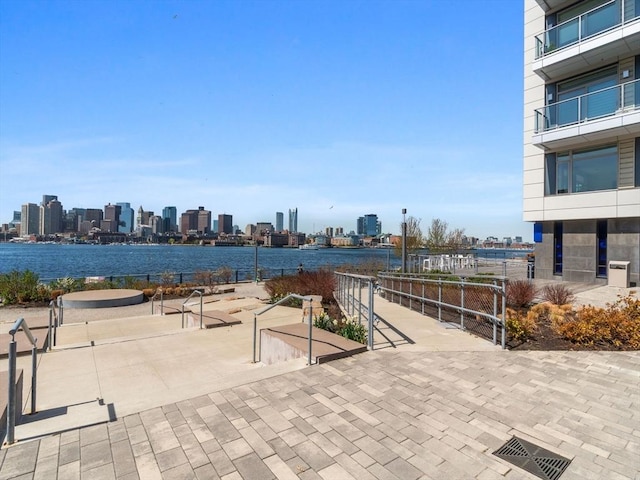 surrounding community with a view of city and a water view