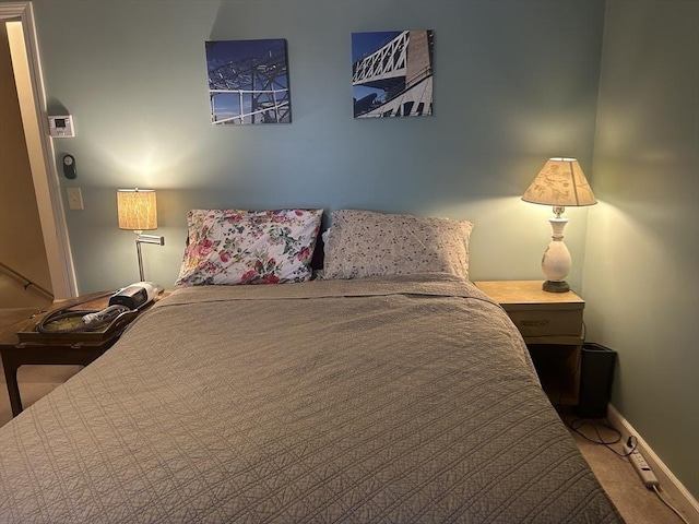 bedroom featuring baseboards and carpet flooring