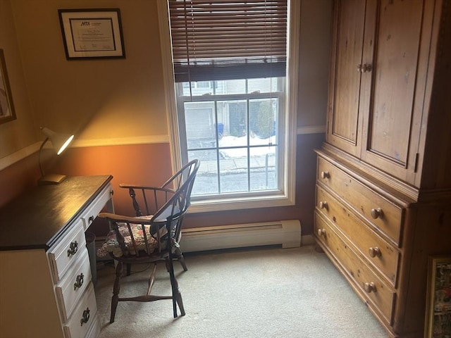 office featuring light carpet and a baseboard heating unit