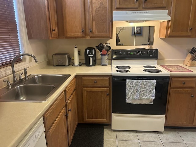 kitchen with under cabinet range hood, light countertops, a sink, and electric range