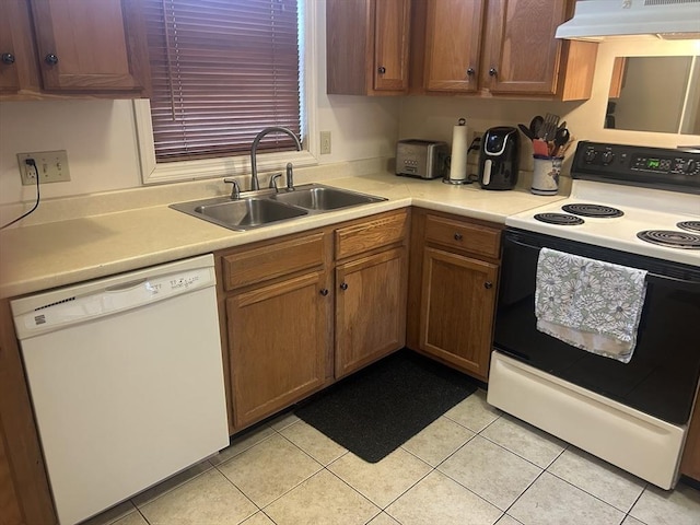 kitchen with light countertops, a sink, range with electric cooktop, dishwasher, and under cabinet range hood