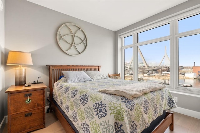 bedroom featuring baseboards and light wood finished floors