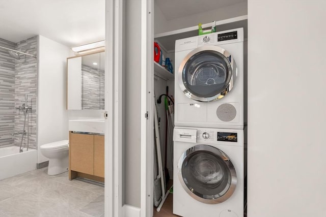 washroom featuring laundry area and stacked washing maching and dryer