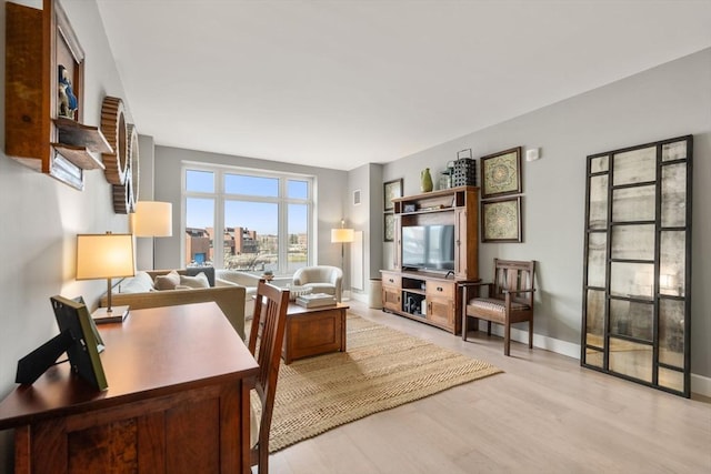 home office featuring wood finished floors and baseboards