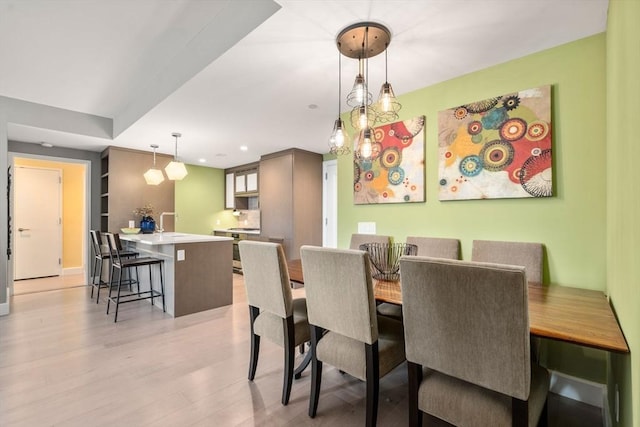 dining space with recessed lighting and light wood-style floors