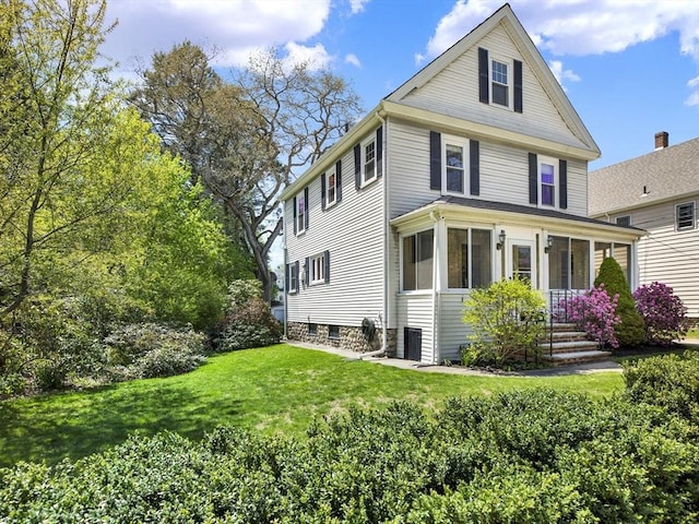 view of front of house featuring a front yard and cooling unit