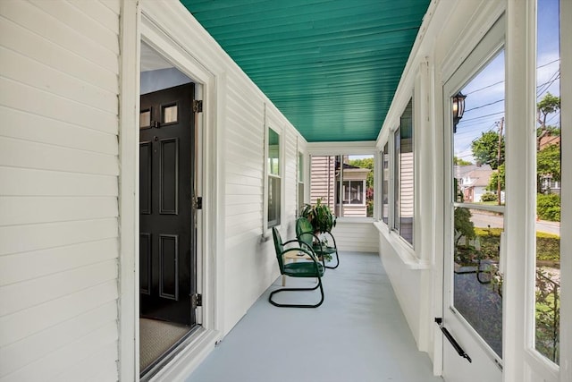 sunroom / solarium with healthy amount of natural light and finished concrete floors