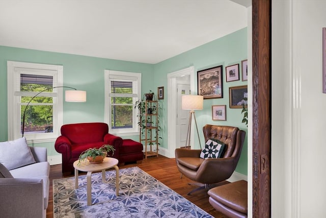 living room with baseboards and wood finished floors