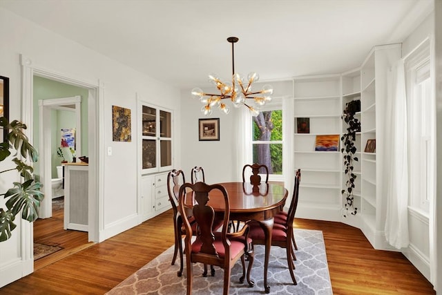dining area featuring a chandelier and wood finished floors
