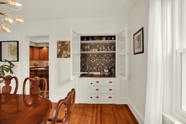 dining room featuring dark wood-style floors and a chandelier