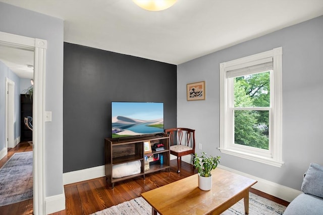 living area featuring wood finished floors and baseboards