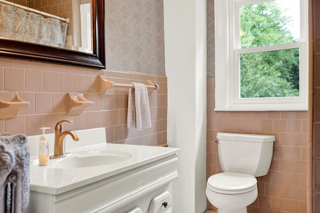 full bathroom featuring tile walls, wallpapered walls, toilet, vanity, and a shower with curtain