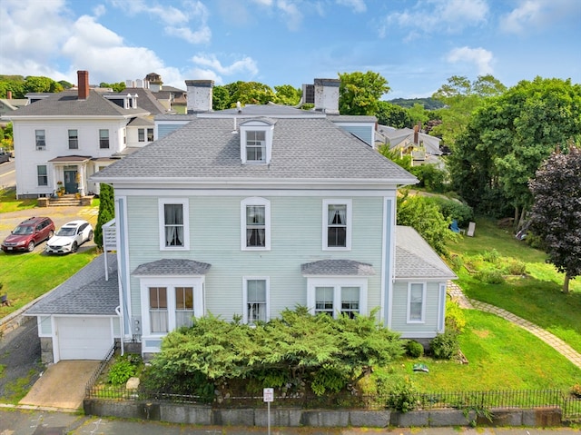 view of front of house featuring a garage and an outbuilding