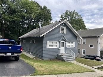 bungalow with entry steps and a front yard