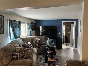 living area with wood finished floors and baseboards