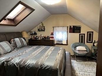 bedroom featuring lofted ceiling and a skylight
