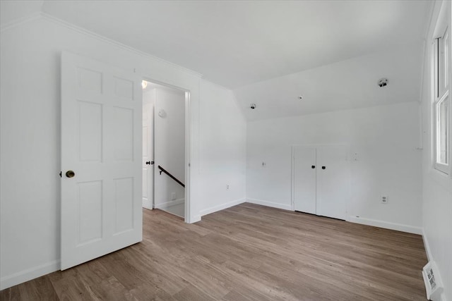 42 Beechwood Dr, Mashpee, MA 02649 - unfurnished bedroom featuring vaulted ceiling, light wood-type flooring, ornamental molding, and a closet