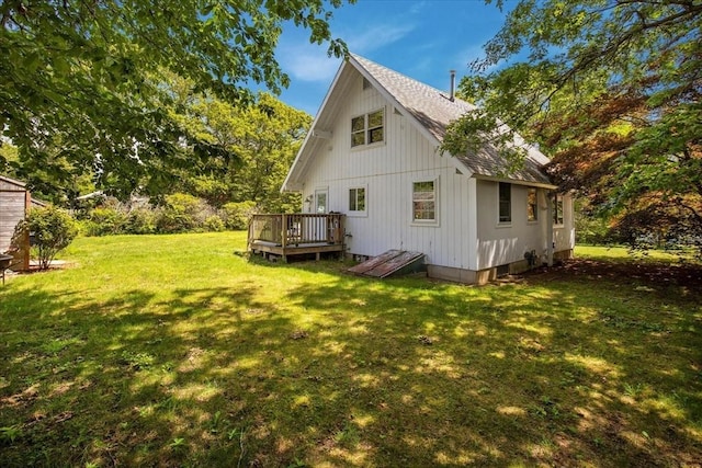 42 Beechwood Dr, Mashpee, MA 02649 - rear view of house with roof with shingles, a wooden deck, and a yard