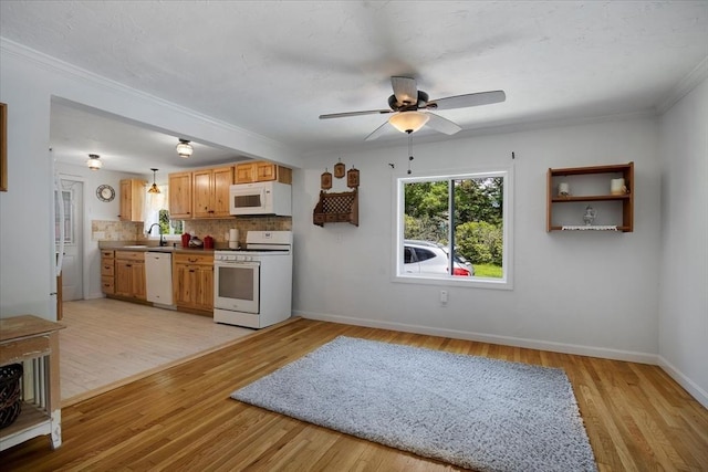 42 Beechwood Dr, Mashpee, MA 02649 - kitchen featuring white appliances, a ceiling fan, light wood-type flooring, decorative backsplash, and crown molding