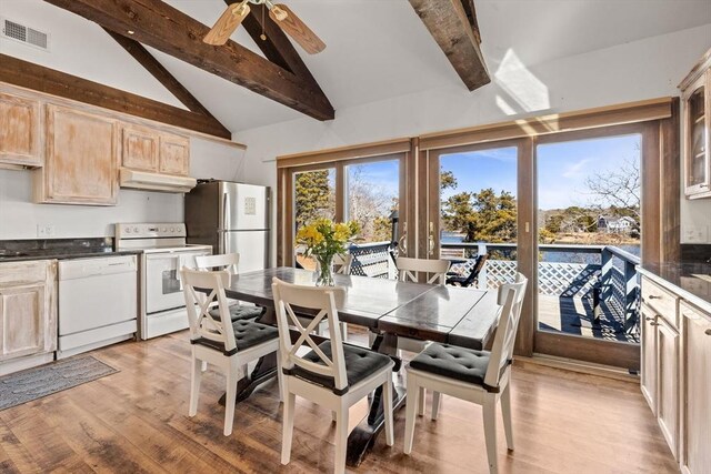 dining space with a ceiling fan, visible vents, beamed ceiling, and light wood finished floors