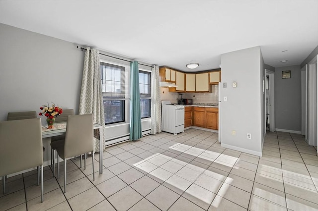 kitchen featuring tasteful backsplash, light tile patterned floors, white stove, and baseboard heating