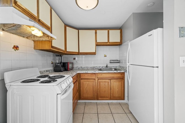 kitchen featuring decorative backsplash, light tile patterned flooring, white appliances, and sink