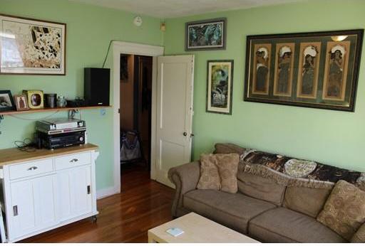 living room featuring dark wood-type flooring