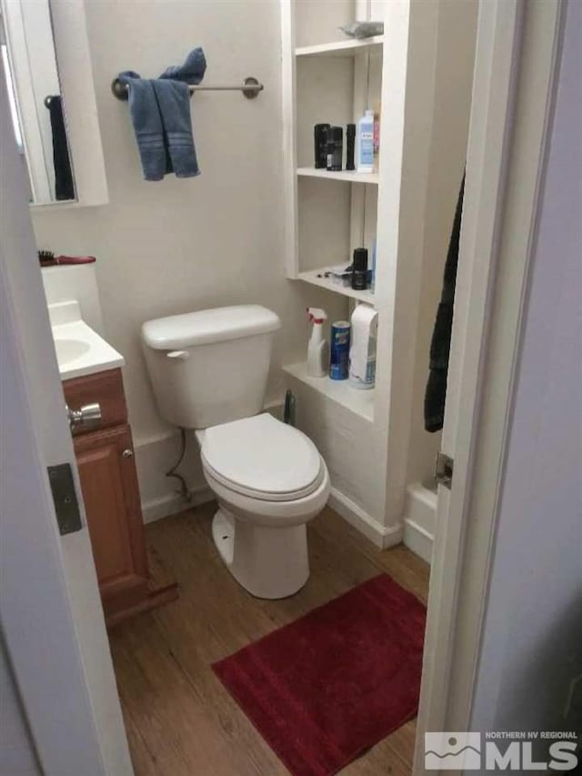full bathroom featuring hardwood / wood-style floors, toilet, vanity, and bathtub / shower combination