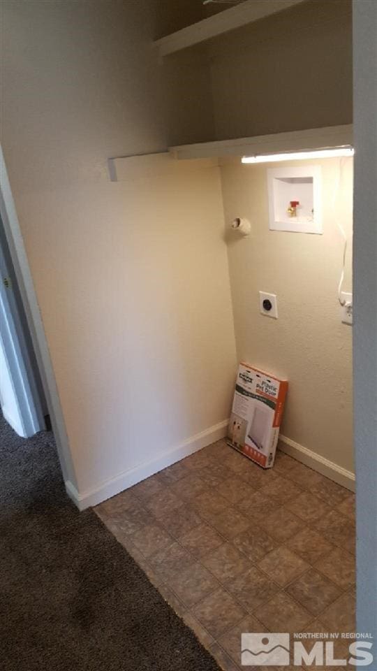 clothes washing area featuring dark tile flooring, washer hookup, and hookup for an electric dryer