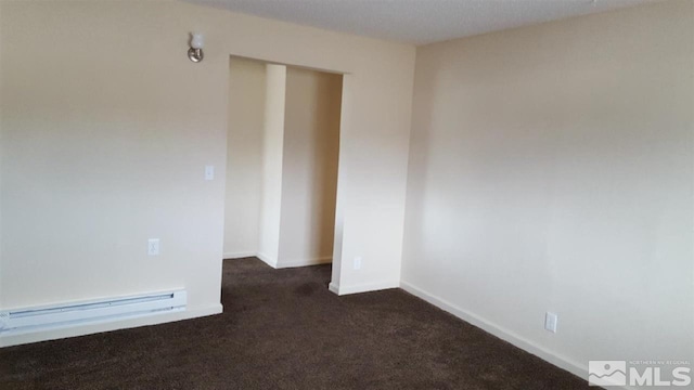 carpeted spare room featuring baseboard heating