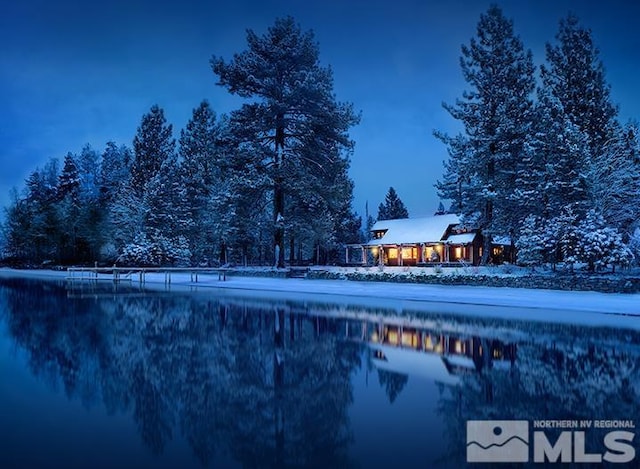 snow covered pool featuring a water view