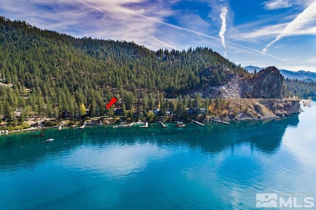 drone / aerial view featuring a water and mountain view