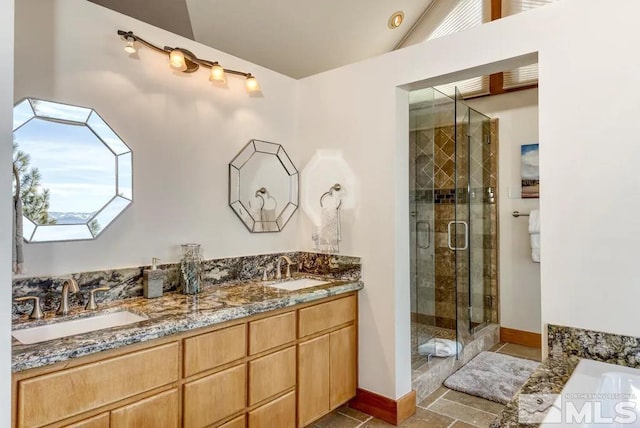 bathroom with a skylight, tile floors, plus walk in shower, and dual bowl vanity