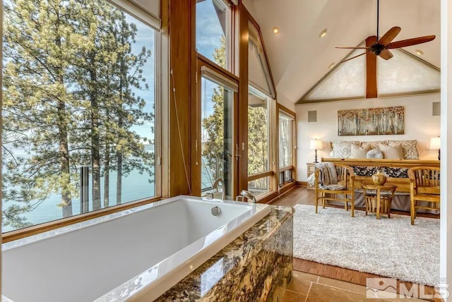 sunroom featuring vaulted ceiling and ceiling fan